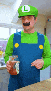 a man dressed as luigi is holding a jar of tomato sauce