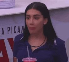 a woman is standing in front of a sign that says a pican