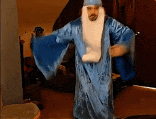 a man dressed in a blue robe with a white beard
