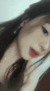 a close up of a woman 's face with red lipstick on