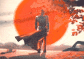 a man standing in front of a large red sun