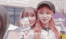 a girl holding a card that says aprilsten bff war on it