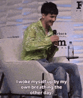 a man sitting in a chair with the words i woke myself up by my own breathing