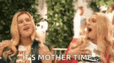 a couple of women are standing next to each other with their mouths open and the words `` it 's mother time '' .