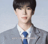 a man in a suit and tie with the words vote for kim junseo above him