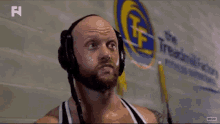 a man wearing headphones is standing in front of a sign that says ' summit factory ' on it .