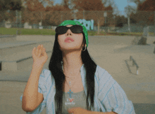 a woman wearing sunglasses and a bandana that says i heart girls