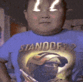 a boy wearing a blue shirt that says " standoff 2 "