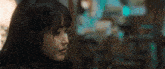 a close up of a woman 's face with a blurry background