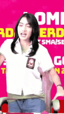a girl in a white shirt is standing in front of a pink background that says " omi nerd "