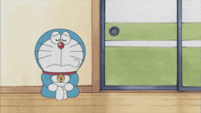 a cartoon character named doraemon is sitting on the floor with his eyes closed