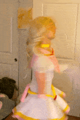 a woman in a pink and white dress is dancing