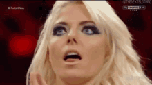 a close up of a woman 's face with a surprised expression on her face .