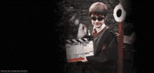 a blurry picture of a person holding a clapper board with the number 6 on it