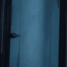 a girl in a white shirt and pink skirt stands in a doorway