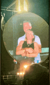 a man and a woman are hugging each other in a circle