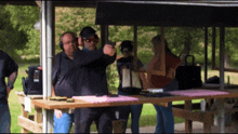 a man wearing ear defenders is pointing a gun
