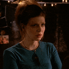 a woman in a blue shirt with the words that did n't work behind her