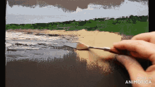 a person is painting a beach scene with the words made in animotica behind them