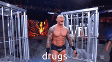 a wrestler in a cage with the word drugs written on the screen