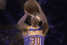 a golden state warriors player is about to shoot the ball