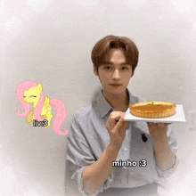 a man is holding a cake in front of a pink pony that says liv3 on it