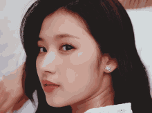a close up of a woman 's face with earrings on