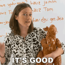 a woman holding a kangaroo with the words it 's good written below her