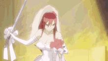 a woman in a wedding dress is holding a bouquet of flowers and a sword .