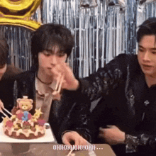 a man is cutting a cake with chopsticks while another man watches .