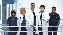 a group of doctors and nurses standing on a balcony