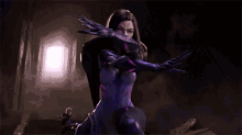a woman in a purple suit is standing in a dark room with purple lights coming out of her hair .