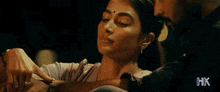 a man is touching a woman 's neck in a movie scene .