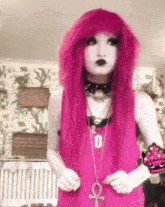 a girl with pink hair is wearing a choker and a necklace with an ankh pendant