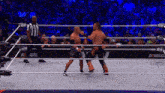 two men in a wrestling ring with a crowd watching and a sign that says aew