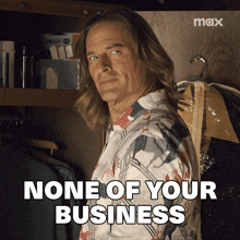 a man standing in a closet with the words none of your business