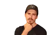 a man with a beard and mustache wearing a black shirt and a hat giving a thumbs up