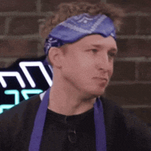a man wearing a purple bandana and a purple apron