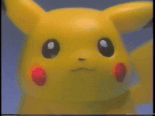 a close up of a pikachu toy with a blue background