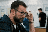 a man with a beard wearing glasses and a stethoscope around his neck