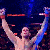 a man in a boxing ring with his arms in the air and a sign that says marc-andre barriault