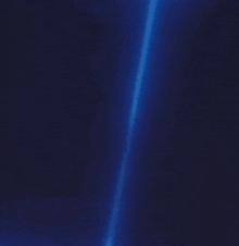 a blue ice cube is floating in the air on a dark blue background