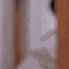 a blurry picture of a man laying in bed .