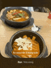 two bowls of food on a wooden table with a caption that says an seoul lan 3 trong tuan