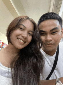 a man and a woman are posing for a picture together