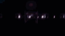 a row of purple and red lights on a black background