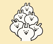 a bunch of rabbits are stacked on top of each other and smiling