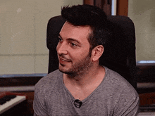 a man sitting in a chair with a microphone in his neck