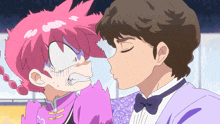 a man in a tuxedo kisses a pink haired girl on the cheek