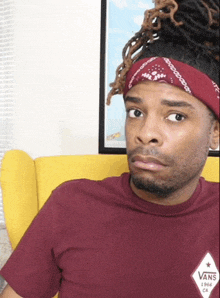 a man wearing a bandana and a vans 1966 shirt